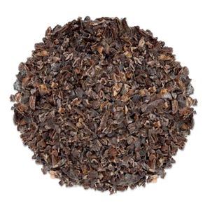 May include: A close-up of a pile of dark brown cacao nibs. The nibs are irregularly shaped and have a slightly rough texture.