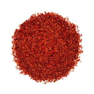 May include: A close-up of a pile of red chili flakes, a common ingredient in many cuisines.
