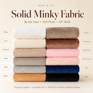 May include: A stack of solid Minky fabric in various colors including white, ivory, oatmeal, taupe, silver, honey, mocha, chestnut, baby pink, peach n cream, navy, and black. The text reads Rovi & Co. Solid Minky Fabric By the Yard Soft Plush 64" Wide.