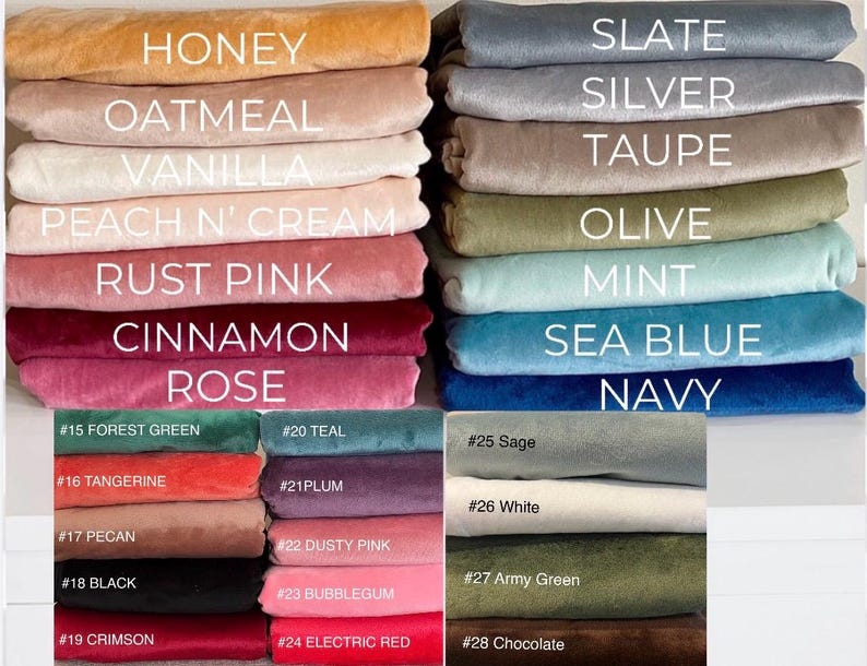 May include: A collection of folded fabric swatches in various colors labeled with text including Honey, Oatmeal, Vanilla, Peach N' Cream, Rust Pink, Cinnamon, Rose, Slate, Silver, Taupe, Olive, Mint, Sea Blue, Navy, Forest Green, Teal, Plum, Dusty Pink, Bubblegum, Electric Red, Crimson, Black, Pecan, Tangerine, Sage, White, Army Green, and Chocolate.