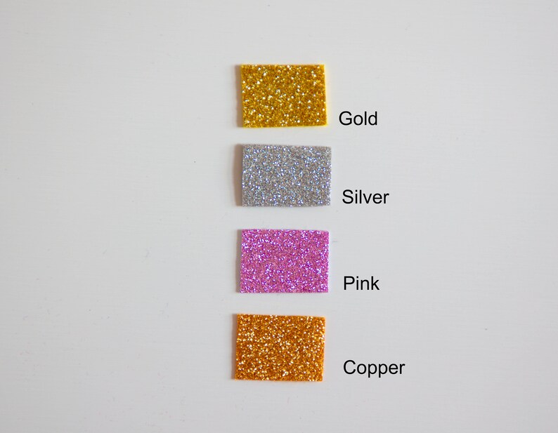 May include: Four square samples of glitter in gold, silver, pink, and copper.
