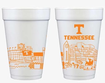May include: Two white foam cups featuring orange line art illustrations. One cup displays a stadium scene with a T flag, while the other shows a campus landscape with the text TENNESSEE and a large orange T logo centered at the top.