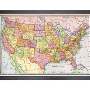 May include: A vintage map of the United States, showing state borders and major cities. The map is printed in a variety of colours, including red, yellow, green, and blue. The map is framed in a black frame.