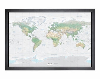 May include: A framed world map with a white background and green and brown topographical details. The map shows the continents and oceans of the world. The frame is black.