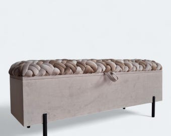 May include: A beige storage bench with a braided fabric top and black metal legs. The bench has a hinged lid and a strap to keep it closed.
