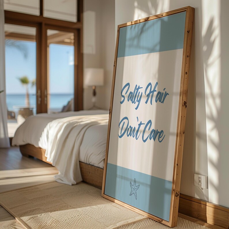 May include: A wooden framed canvas print with a blue and white background. The text "Salty Hair Don't Care" is written in blue cursive font. A blue starfish is in the bottom right corner.