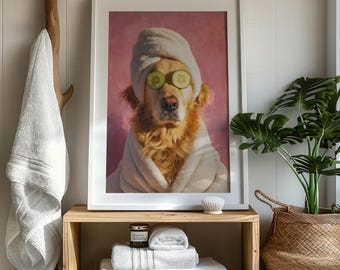 May include: A framed print of a Golden Retriever in a spa setting, wearing a robe, cucumber slices, and a towel. The print sits on a wooden shelf with white towels, a candle, and a brush. A hanging towel and a potted plant are also visible.