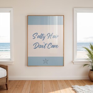 May include: A framed print with a light blue background and white text that reads "Salty Hair Don't Care". A small blue starfish is centered below the text.