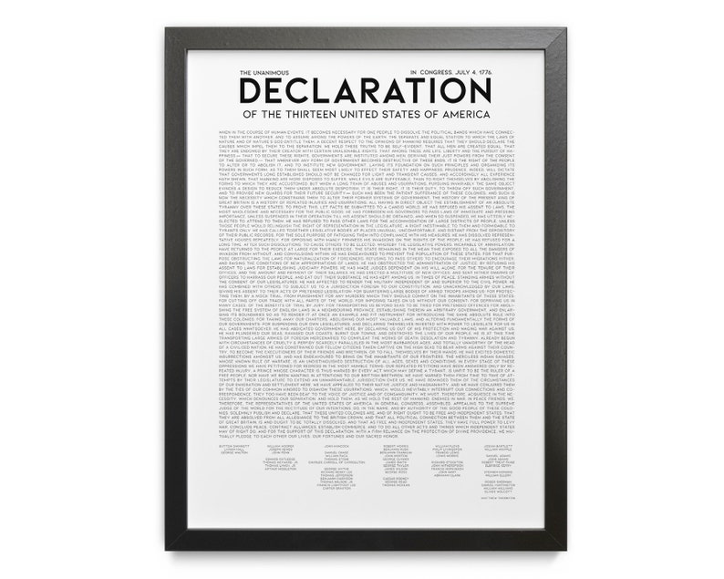 May include: A framed print of the Declaration of Independence. The text is in black on a white background, with the title "Declaration of the Thirteen United States of America" at the top. The frame is black.