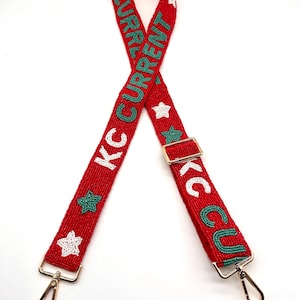 May include: Red beaded bag strap with white stars and green "KC CURRENT" lettering.