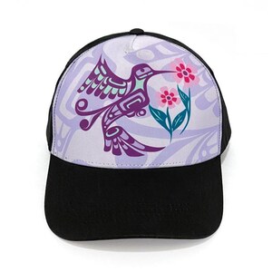May include: A black baseball cap with a purple hummingbird and pink flowers on a lavender background.