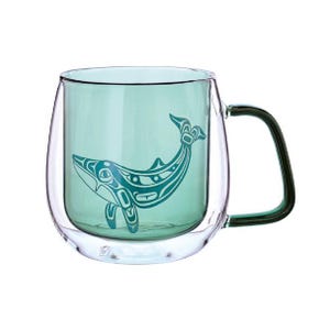 May include: A double-walled glass mug with a green tint and a handle. The mug features a stylized design of a whale in teal blue.