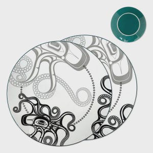 May include: Two round white ceramic plates featuring a stylized octopus illustration in black and grey ink. The design includes intricate tentacle patterns and geometric shapes. A separate small teal saucer is positioned in the upper right corner.