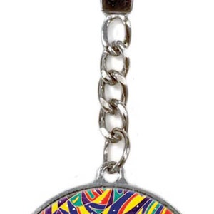 May include: A silver keychain with a round charm featuring a black background with three white polar bears dancing on a colorful patterned surface. The charm is surrounded by a silver ring.