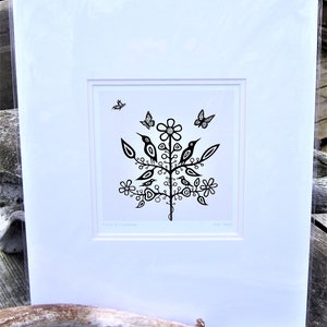 May include: Black and white print of a stylised tree with birds and butterflies. The print is framed and mounted. The text "Tree of Wonder" is at the bottom of the print.