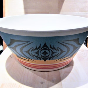 May include: A large, white bowl with a blue, black, yellow, and red geometric design. The bowl is made of bamboo and is ideal for serving salads, pasta, or fruit.