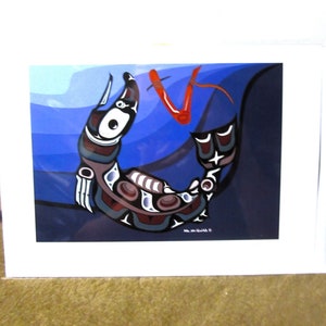 May include: A stylized illustration of a salmon swimming in blue water. The salmon is depicted in a traditional Native American style with geometric patterns and colors. The salmon is red, blue, black, and white. The water is a deep blue with lighter blue waves. The image is framed in a white border.