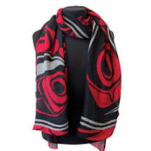May include: A black and red scarf featuring a stylised design of a bird's head. The design is in shades of red, black, and white.