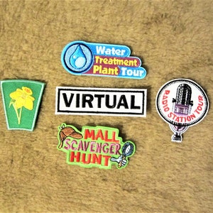 May include: Five colourful embroidered patches with various themes. The patches include a water treatment plant tour, a virtual tour, a radio station tour, a mall scavenger hunt, and a daffodil.