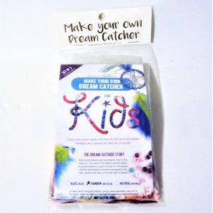 May include: A colourful package for a kids' craft kit to make dream catchers. The package shows a colourful illustration of the word "Kids" with a star and feathers. The text on the package reads "Make Your Own Dream Catcher for Kids".
