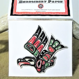 May include: Embroidered patch of a stylised black, red and green bird with a white background. The patch is labelled "Embroidery Patch" and "Copyright © 2005-Golden Top All rights reserved".
