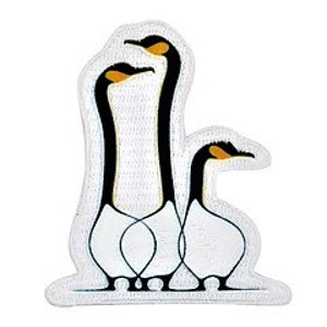 May include: White embroidered patch featuring three stylised geese in a row, with black necks and yellow beaks. The geese are standing on a white base with a blue wave pattern.