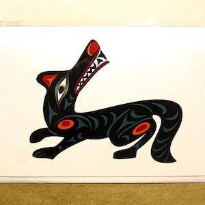 May include: A black and green stylised wolf with red accents, howling with its mouth open. The wolf is depicted in a traditional Northwest Coast Indigenous art style.