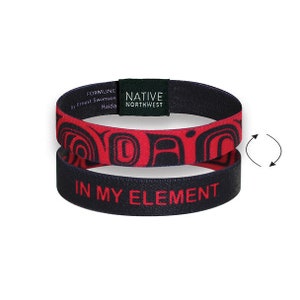 May include: A black and red reversible wristband with the text "In My Element" and a Native Northwest Formline design by Ernest Swanson Haida.