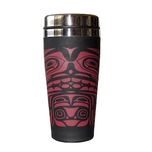 May include: A black travel mug with a red and black design of a stylized face. The mug has a silver lid.