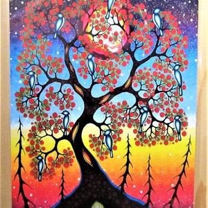 May include: A colourful art print depicting a stylised tree with red berries and blue birds against a starry night sky. The tree's trunk is dark, and the background transitions from red to yellow. The artwork is framed.