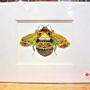 May include: A colorful, detailed illustration of a bee with intricate patterns in yellow, green, red, and orange. The artwork is framed in a white mat, showcasing the vibrant insect design. The image is a print.