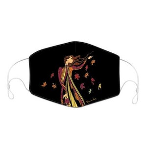 May include: A black face mask featuring a colourful illustration of a woman with flowing hair and leaves. The woman is wearing a long dress with a flowing skirt. The leaves are in shades of red, orange, yellow, and green. The text "Yvonne Ball" is printed in the bottom right corner of the mask.