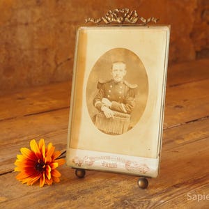Good size antique French photo or picture frame with thick beveled glass and brass bow ribbon