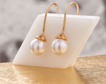 White pearl long drop earrings in gold