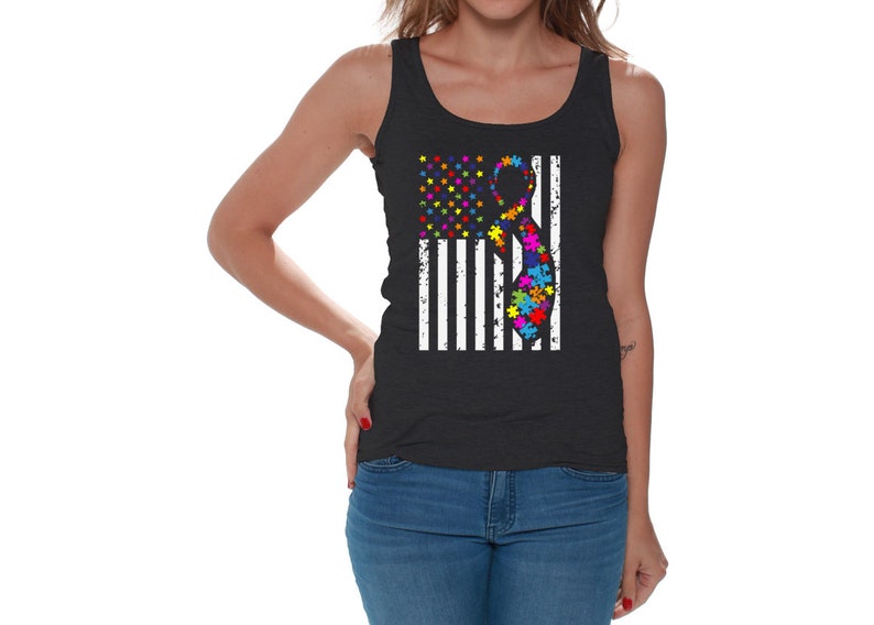 May include: A black tank top with a white and blue American flag design. The flag has a rainbow colored ribbon with puzzle pieces in the center.