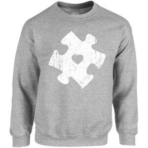 May include: A grey sweatshirt with a white distressed jigsaw piece design featuring a heart in the centre.