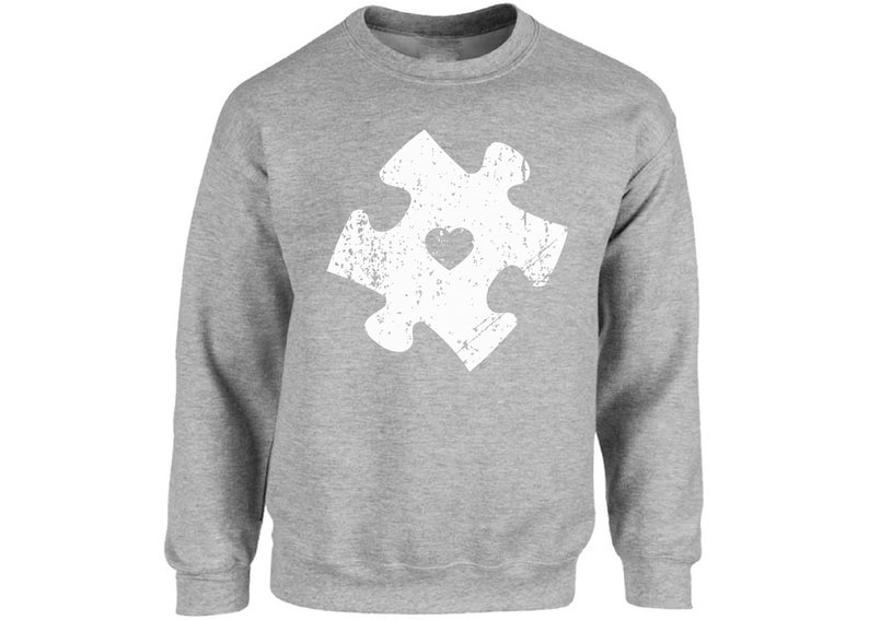 May include: A grey sweatshirt with a white distressed jigsaw piece design featuring a heart in the centre.