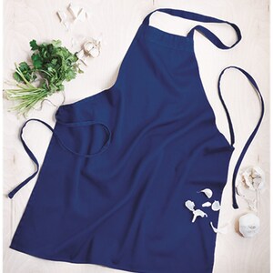 May include: A dark blue apron with adjustable neck and waist ties. The apron is made of a durable, easy-to-clean fabric.