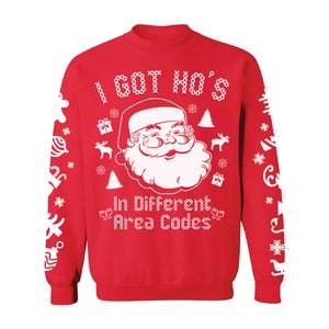 May include: Red Christmas sweater with a white design featuring Santa Claus and the text "I got ho's in different area codes".