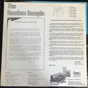 May include: A vintage vinyl record album titled "The Random Sample." The album cover features text and a drawing of several figures. The back cover lists song titles and credits. The album is a stereo, hi-fidelity recording.