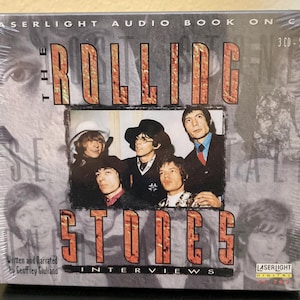 May include: A CD set titled "The Rolling Stones Interviews" by Geoffrey Giuliano. The cover features a photo of the band members and the Laserlight Digital logo. The packaging is sealed in plastic.