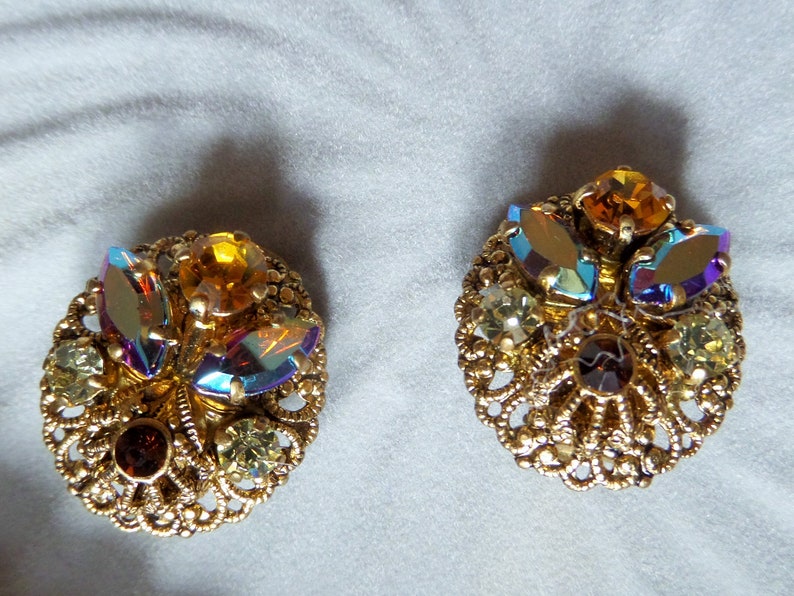 Vintage Round Circle Ornate Gold Tone Filigree Clip On Earrings with Dazzling Aurora Borealis Rhinestones Made In West Germany