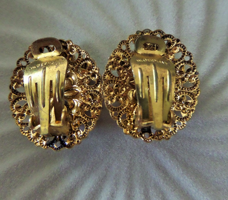 Vintage Round Circle Ornate Gold Tone Filigree Clip On Earrings with Dazzling Aurora Borealis Rhinestones Made In West Germany