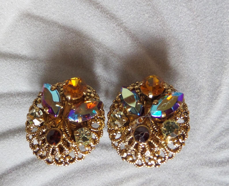 Vintage Round Circle Ornate Gold Tone Filigree Clip On Earrings with Dazzling Aurora Borealis Rhinestones Made In West Germany