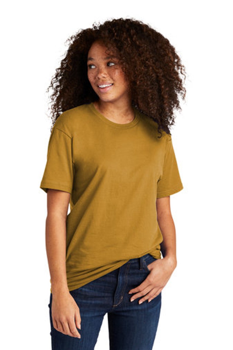 Peut inclure: Un t-shirt &agrave; manches courtes jaune moutarde avec un col rond. Le t-shirt est fait d'un tissu doux et confortable, parfait pour tous les jours.