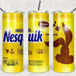 May include: A yellow and blue Nesquik chocolate milk tumbler with a brown bunny silhouette. The tumbler has the text "Nesquik" in blue and "Chocolate Lowfat Milk" in brown. The bunny silhouette is filled with small, black and white text. The tumbler has a straw and a lid.