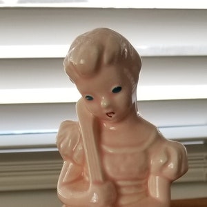 Vintage pink ceramic girl with an instrument