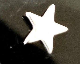 May include: A white star-shaped ornament against a dark background.