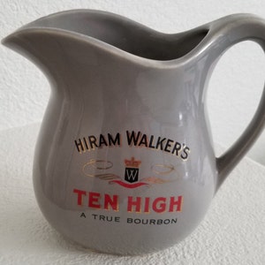 May include: Grey ceramic jug with a gold and black logo that reads "Hiram Walker's Ten High A True Bourbon".