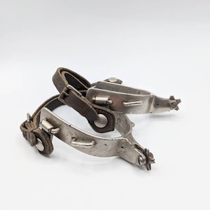 Pair of Marked North and Judd Spurs with 5 Point Star Rowels with Straps